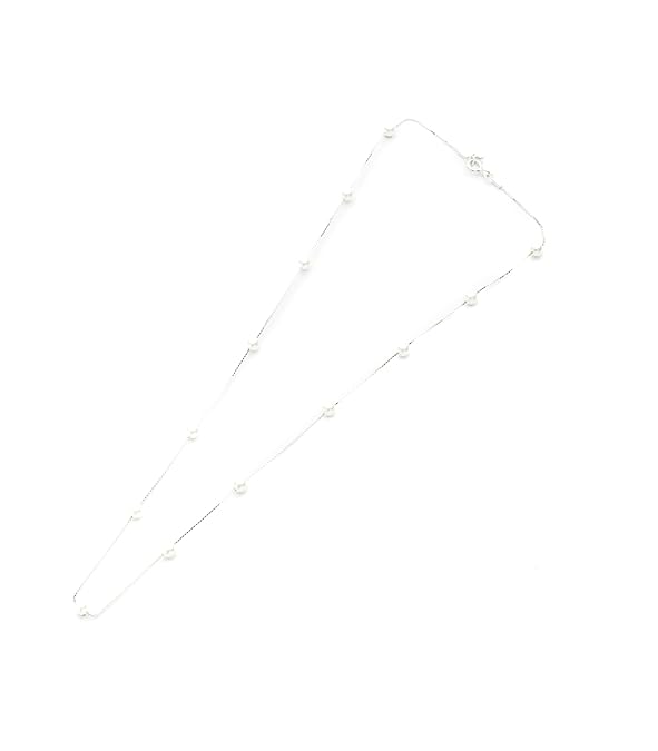 Flat lay view of a 925 sterling silver station necklace with 3mm freshwater pearls.