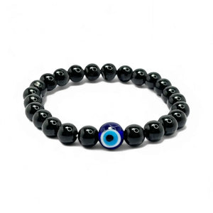 A stylish bracelet featuring black obsidian beads and a single blue evil eye charm at the center.