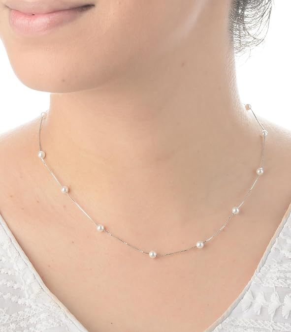 Model wearing a 16-inch minimalist pearl station necklace in sterling silver.