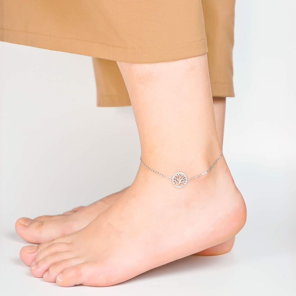 Model wearing the Tree of Life sterling silver anklet with cropped khaki pants.